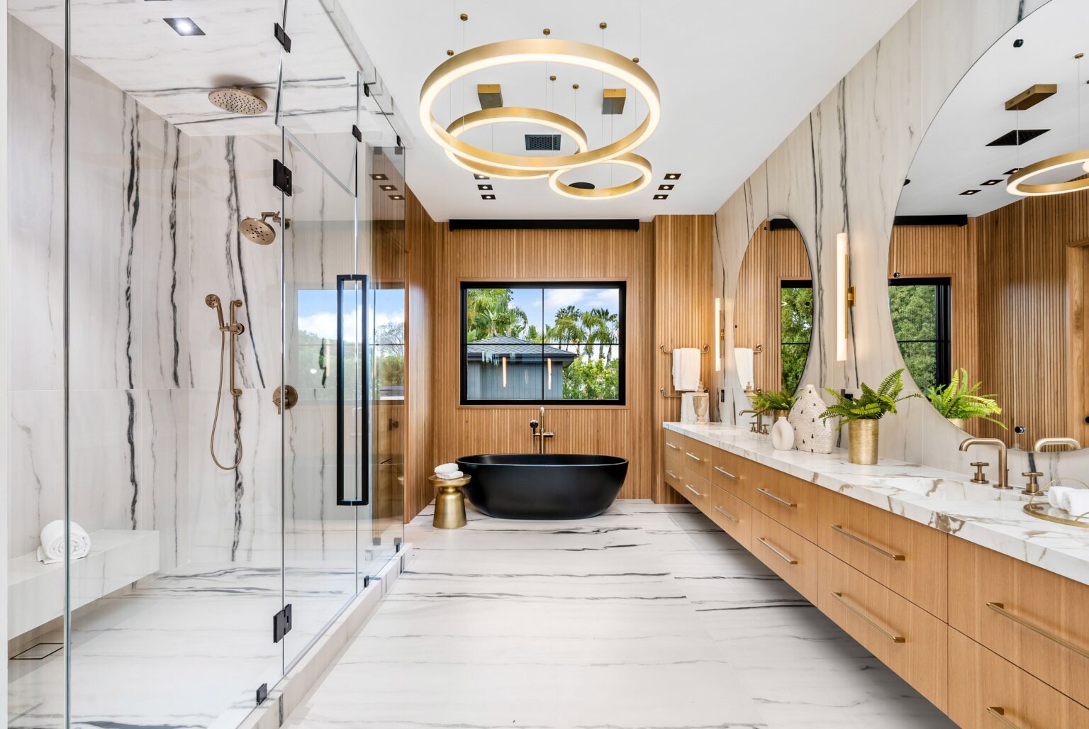 Luxurious modern bathroom with a black tub, marble walls, and large glass shower, featuring elegant lighting and wooden accents.