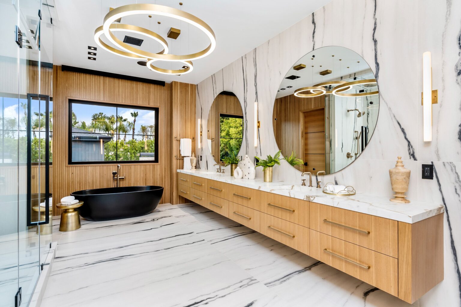 A luxury modern bathroom featuring a black bathtub and elegant marble flooring.
